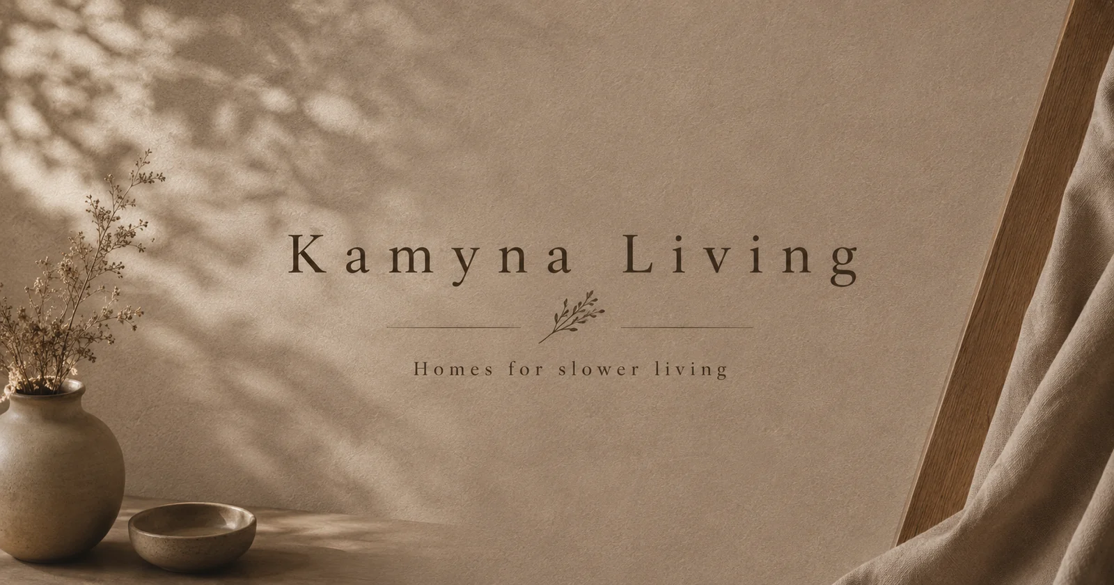 Kamyna Living identity composed on a tactile wall with ceramics, linen, and botanical shadows